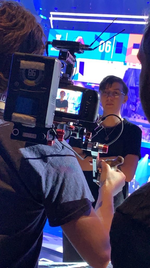 A picture of Danielle being interviewed by camera man during a gaming event.